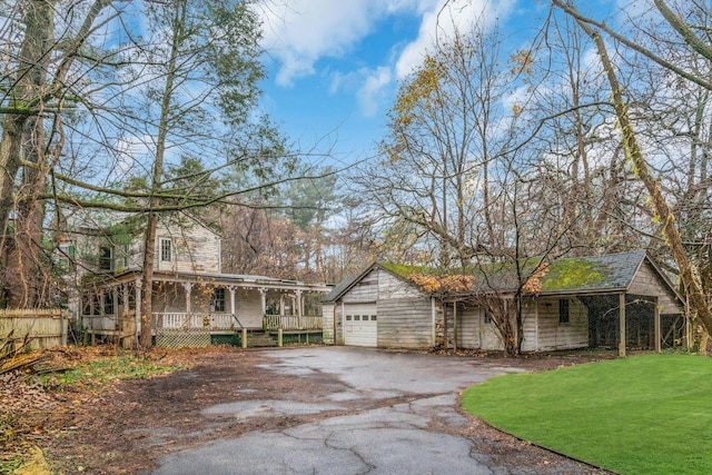 115 Duck Pond Rd, Glen Cove, NY 11542 - view of front of home featuring covered porch, a garage, and a front yard