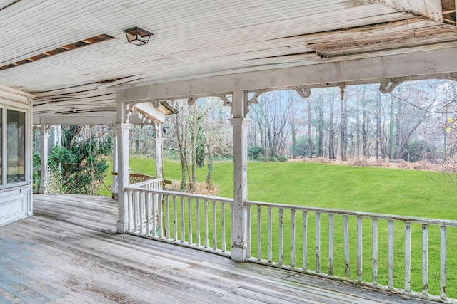 wooden deck featuring a yard