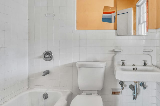 bathroom featuring toilet and a tub