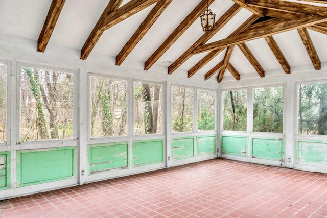 unfurnished sunroom featuring vaulted ceiling with beams