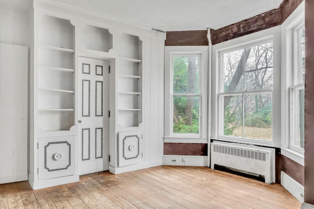 interior space with radiator heating unit and a healthy amount of sunlight