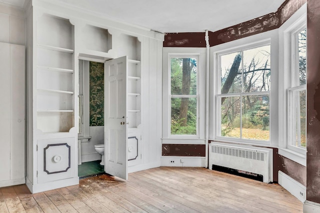 unfurnished sunroom featuring radiator