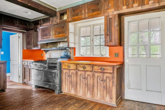 kitchen featuring beamed ceiling, wood-type flooring, and gas stove