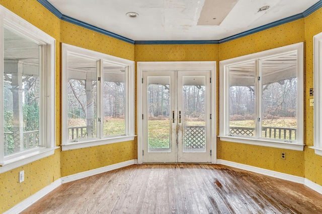 unfurnished sunroom featuring a wealth of natural light and french doors