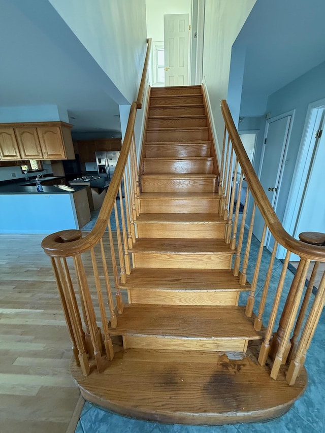 staircase with hardwood / wood-style floors