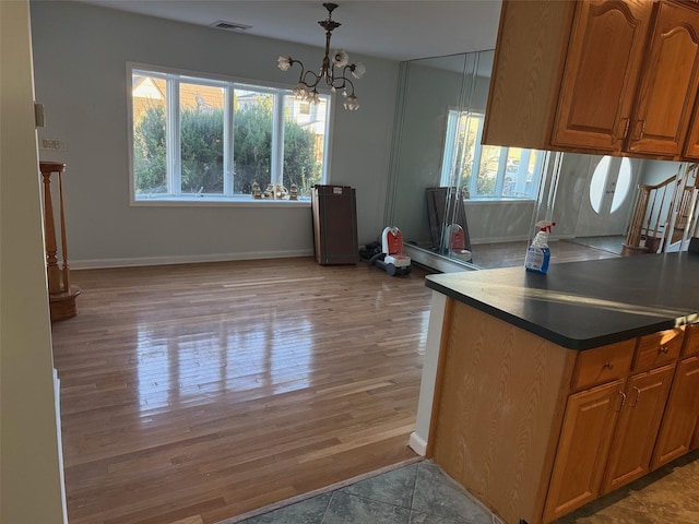 kitchen featuring a chandelier, wood-type flooring, and hanging light fixtures