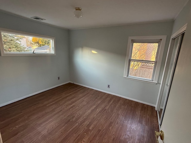 unfurnished room featuring dark hardwood / wood-style floors