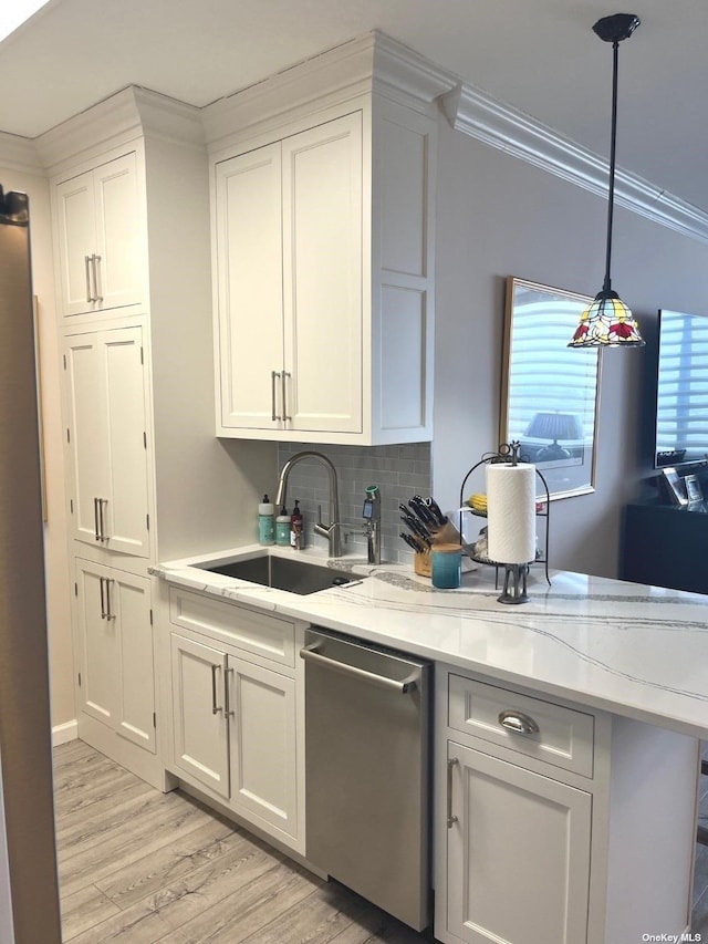 kitchen with sink, white cabinets, light wood-type flooring, and appliances with stainless steel finishes