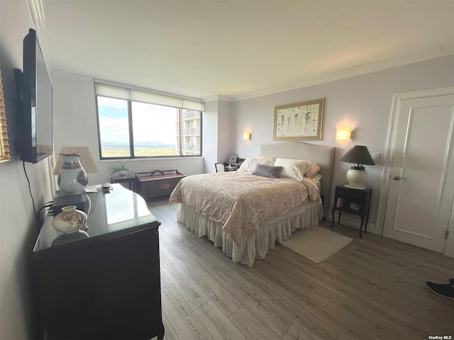 bedroom featuring light hardwood / wood-style floors and ornamental molding