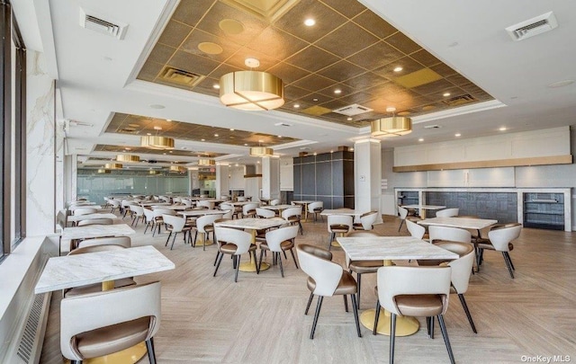 dining room featuring light parquet flooring and a tray ceiling