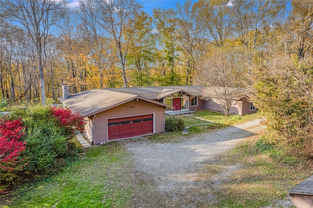 view of front of property featuring a garage and a front lawn