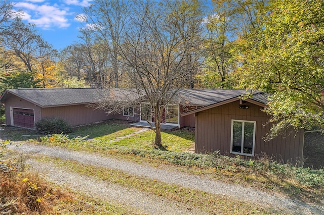 view of property exterior with a garage and a yard