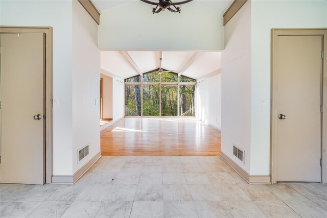 interior space with lofted ceiling with beams and light wood-type flooring