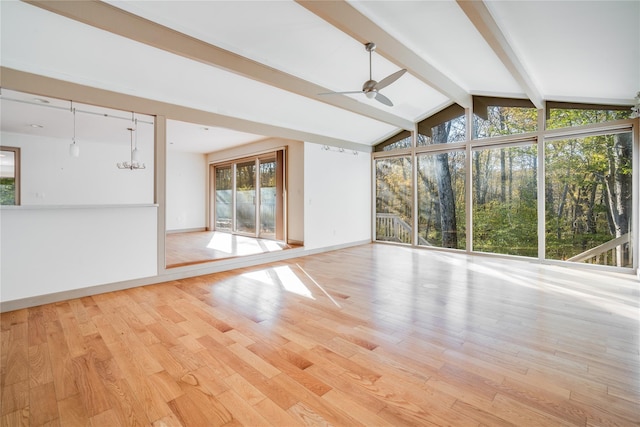 interior space featuring ceiling fan and lofted ceiling with beams