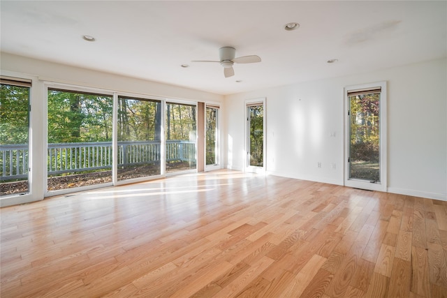 empty room with light hardwood / wood-style flooring and ceiling fan