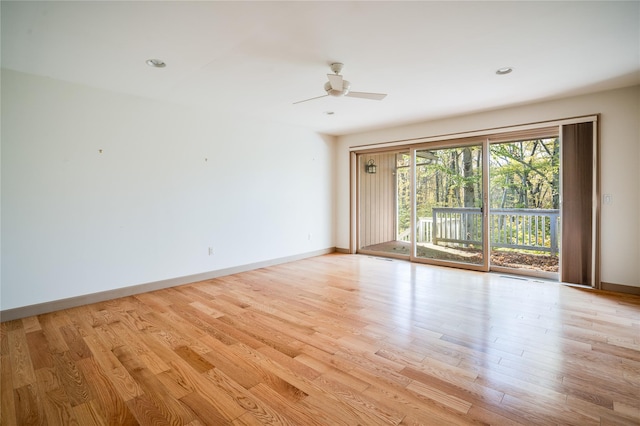 empty room with ceiling fan and light hardwood / wood-style floors