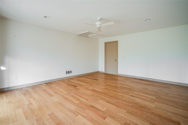 spare room with ceiling fan and light wood-type flooring