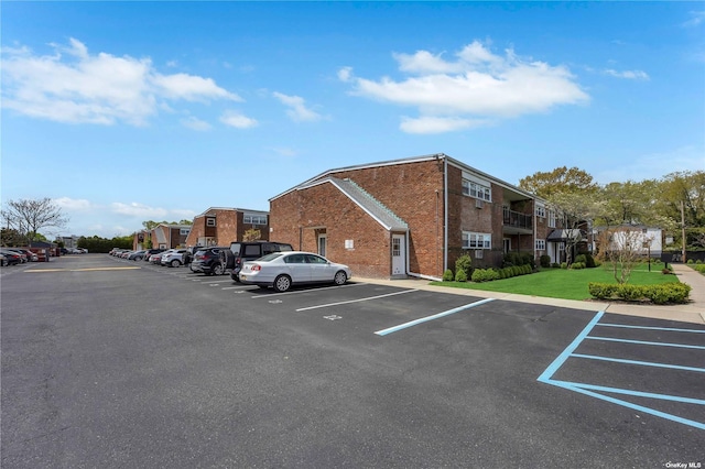 view of parking / parking lot with a lawn