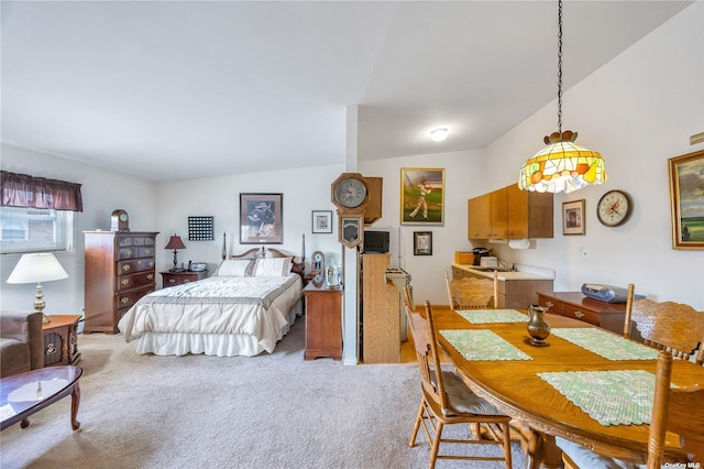 bedroom with light colored carpet and vaulted ceiling