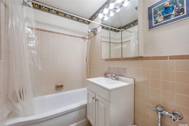 bathroom featuring shower / bath combo, vanity, and tile walls