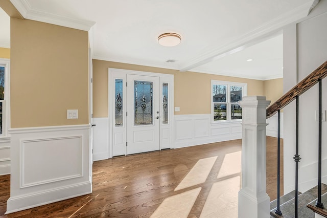 entrance foyer with hardwood / wood-style floors and ornamental molding