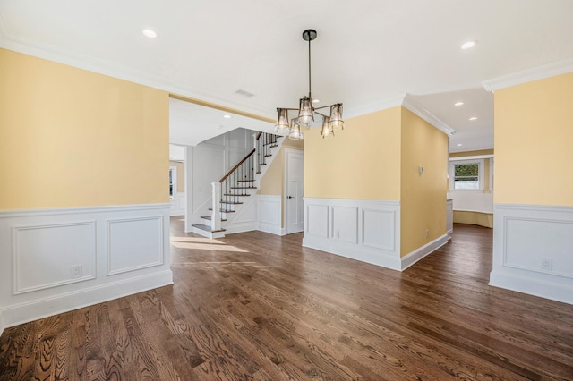 interior space featuring a chandelier, dark wood-type flooring, and ornamental molding