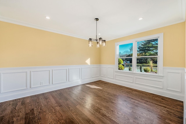 unfurnished dining area featuring ornamental molding, dark hardwood / wood-style floors, and a notable chandelier