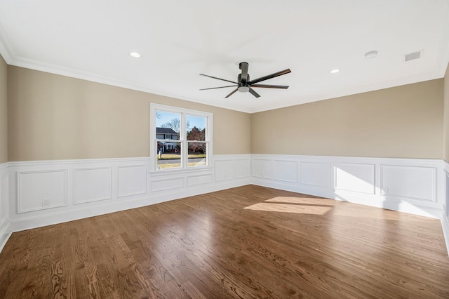 unfurnished room featuring ceiling fan, ornamental molding, and hardwood / wood-style flooring