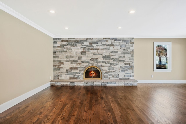 unfurnished living room with hardwood / wood-style floors, a stone fireplace, and ornamental molding