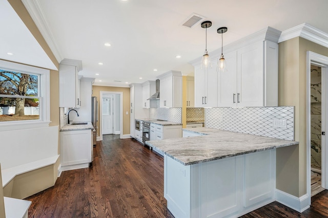 kitchen featuring kitchen peninsula and white cabinetry