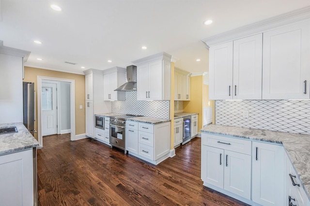 kitchen with white cabinetry, dark hardwood / wood-style flooring, wall chimney exhaust hood, and stainless steel appliances