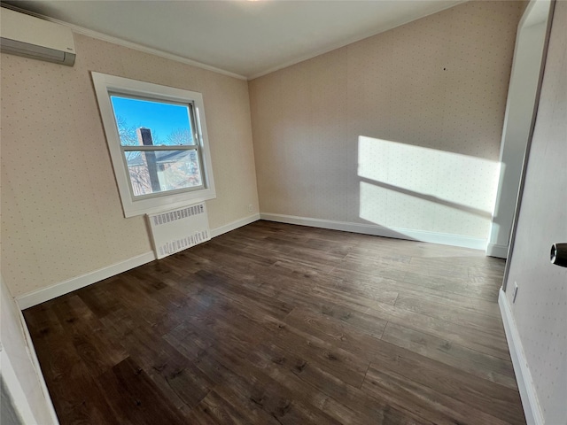 spare room with radiator, ornamental molding, a wall mounted air conditioner, and hardwood / wood-style flooring