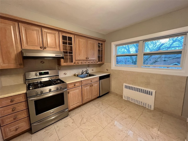 kitchen featuring radiator heating unit, sink, and appliances with stainless steel finishes