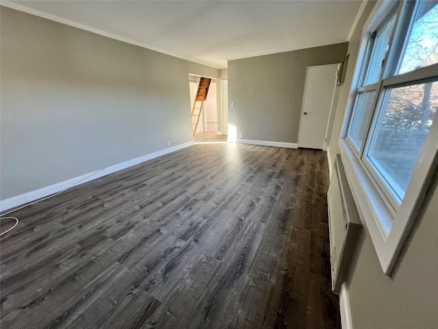 unfurnished room featuring dark hardwood / wood-style flooring and crown molding