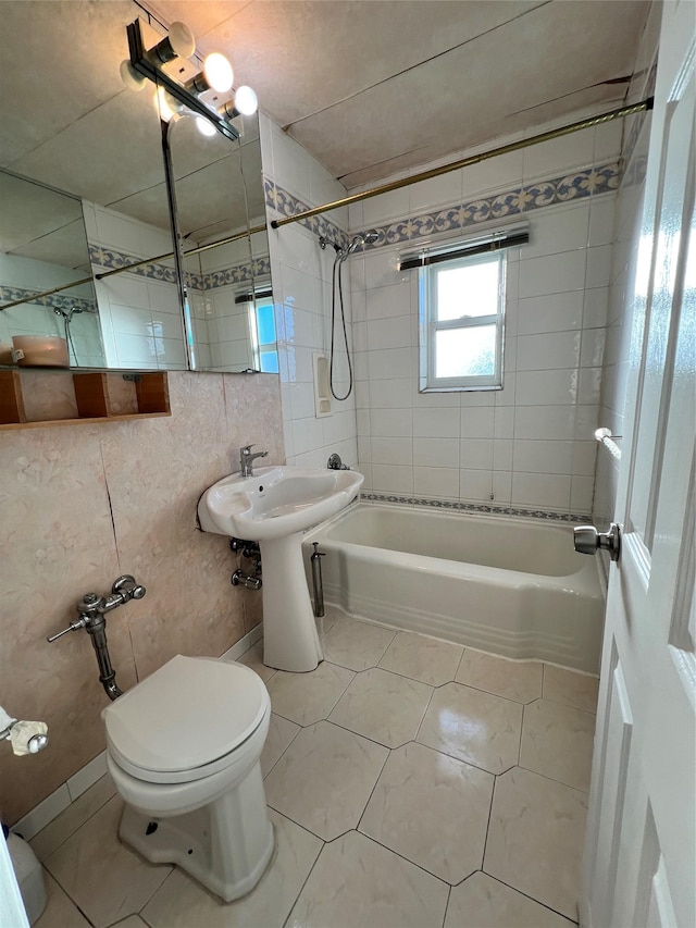 bathroom featuring tile patterned flooring, tiled shower / bath combo, and toilet