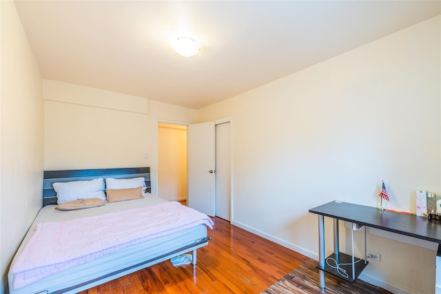 bedroom featuring hardwood / wood-style floors and a closet