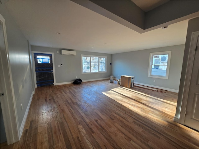 entryway featuring wood-type flooring and an AC wall unit