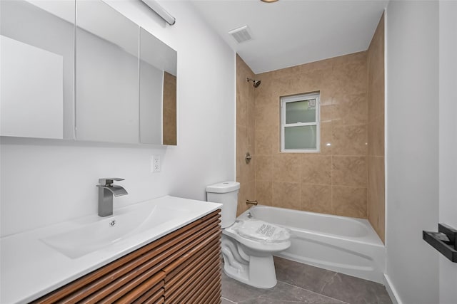 full bathroom with tile patterned flooring, vanity, toilet, and tiled shower / bath