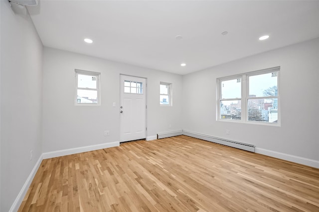 interior space with light hardwood / wood-style floors and a baseboard heating unit