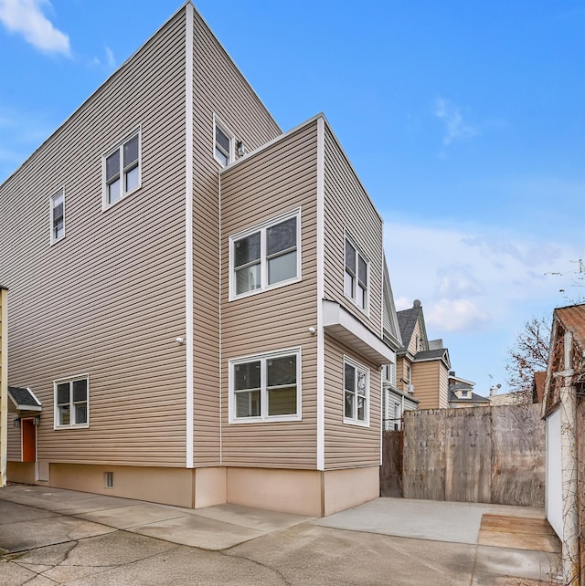 view of side of property with a patio area