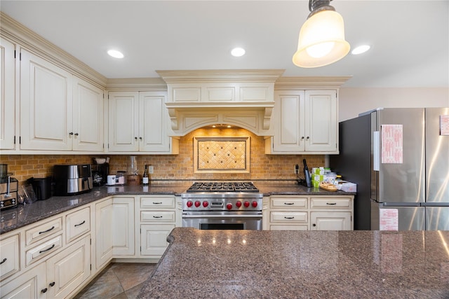 kitchen with stainless steel appliances, tasteful backsplash, dark stone counters, decorative light fixtures, and custom exhaust hood