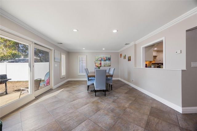 dining room featuring crown molding