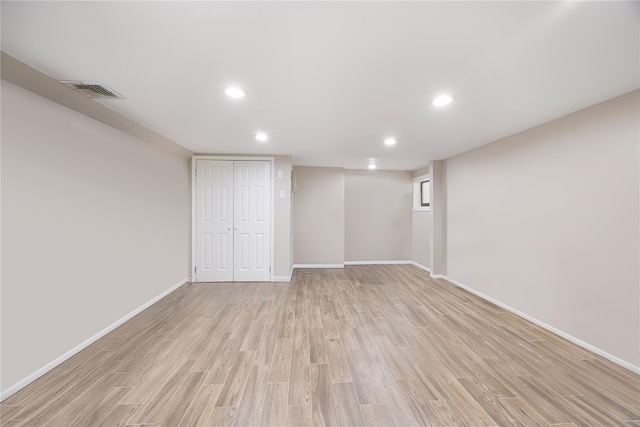 basement with light hardwood / wood-style floors