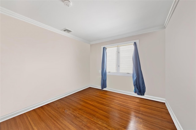 unfurnished room with wood-type flooring and ornamental molding