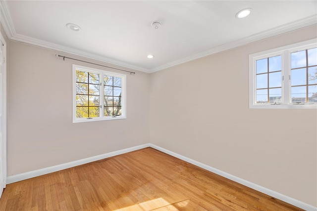 unfurnished room featuring ornamental molding and light hardwood / wood-style flooring