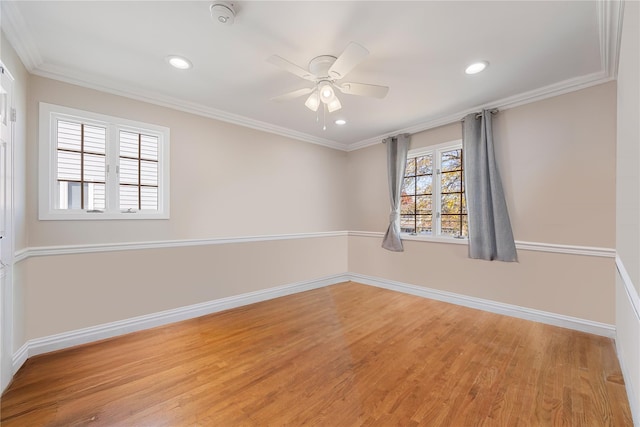 empty room with ceiling fan, light wood-type flooring, and crown molding