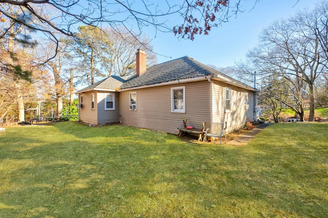 rear view of property featuring a yard