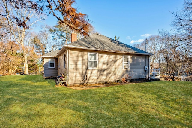 rear view of house featuring a yard and cooling unit