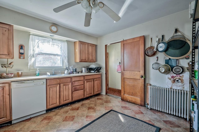 kitchen with white dishwasher, ceiling fan, radiator heating unit, and sink