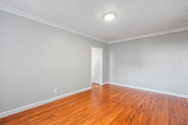 unfurnished room with crown molding and light hardwood / wood-style flooring